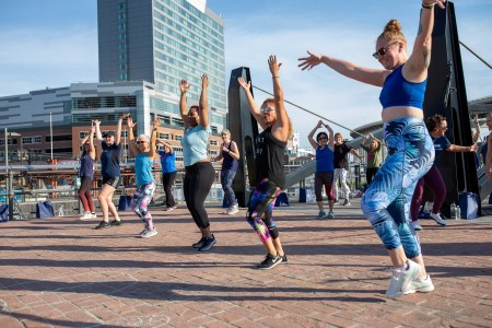 Low-angle shot of a free outdoor fitness class at Canalside in Western New York.
