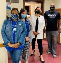 Four people from the Latino Connection and the CATE Mobile Unit (Pennsylvania) wearing protective masks.