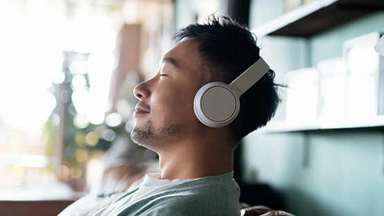 young adult listening to music while taking a rest