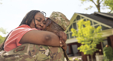 photo of a man in the military hugging a women